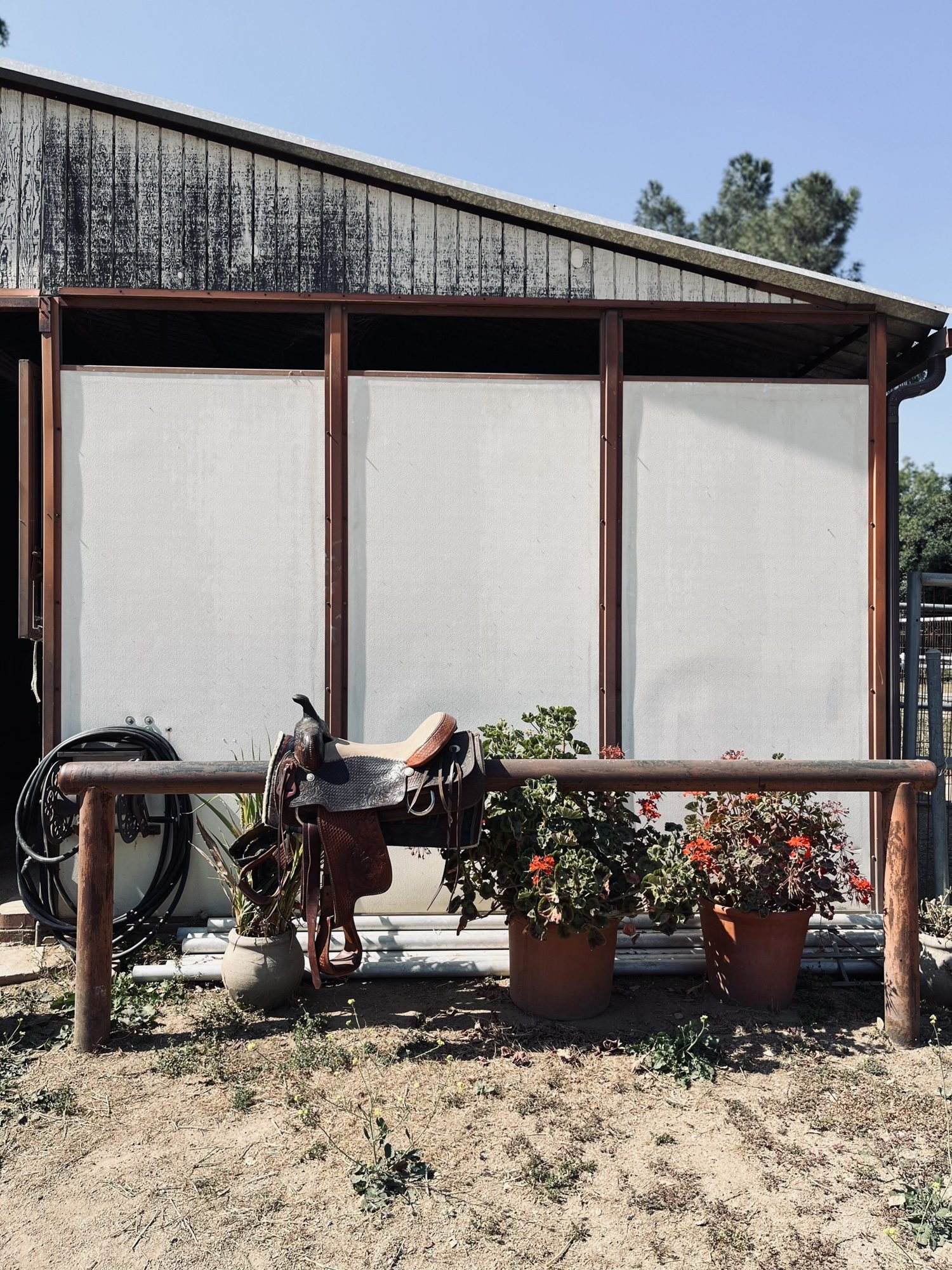Western saddle resting on a rail outside the barn, Shadow Hills Ranch